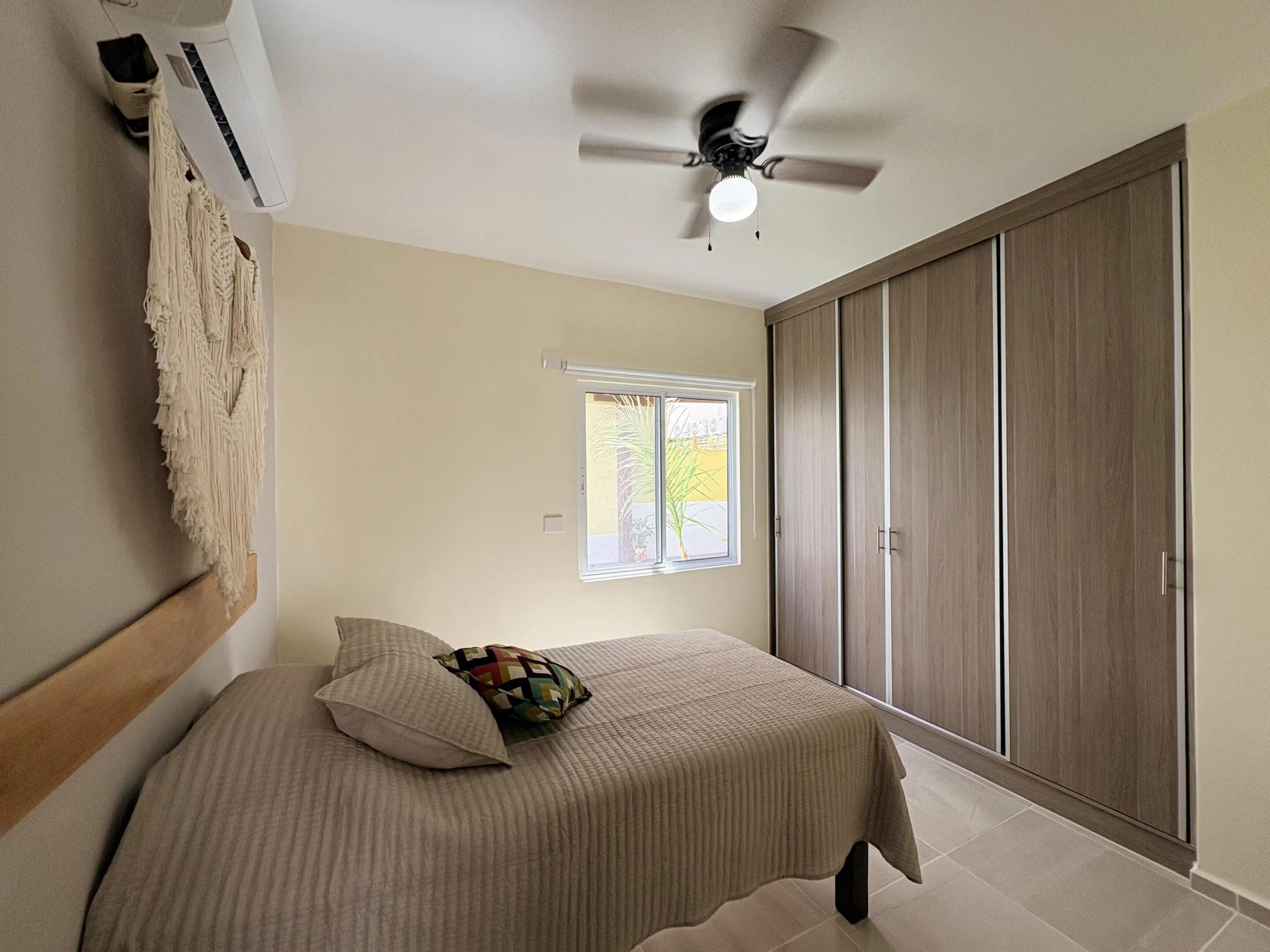 Minimal bedroom with bed, wardrobe, ceiling fan
