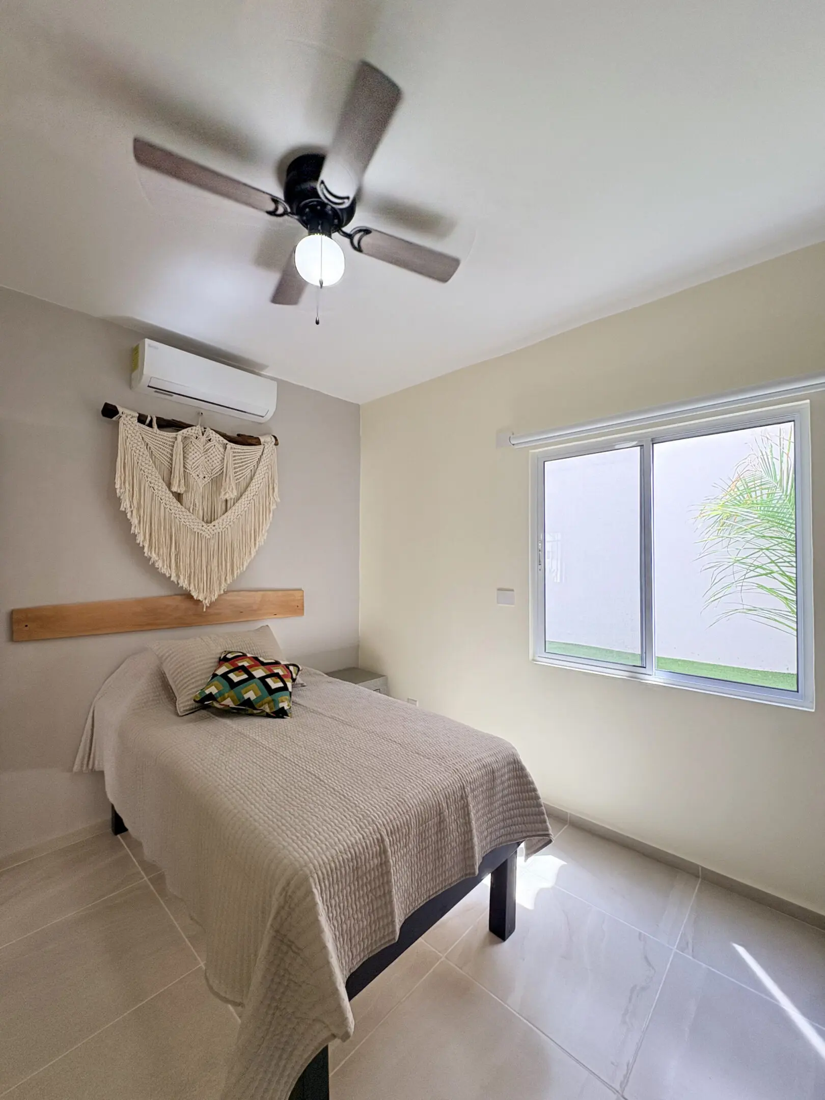 Minimalist bedroom with single bed and macrame