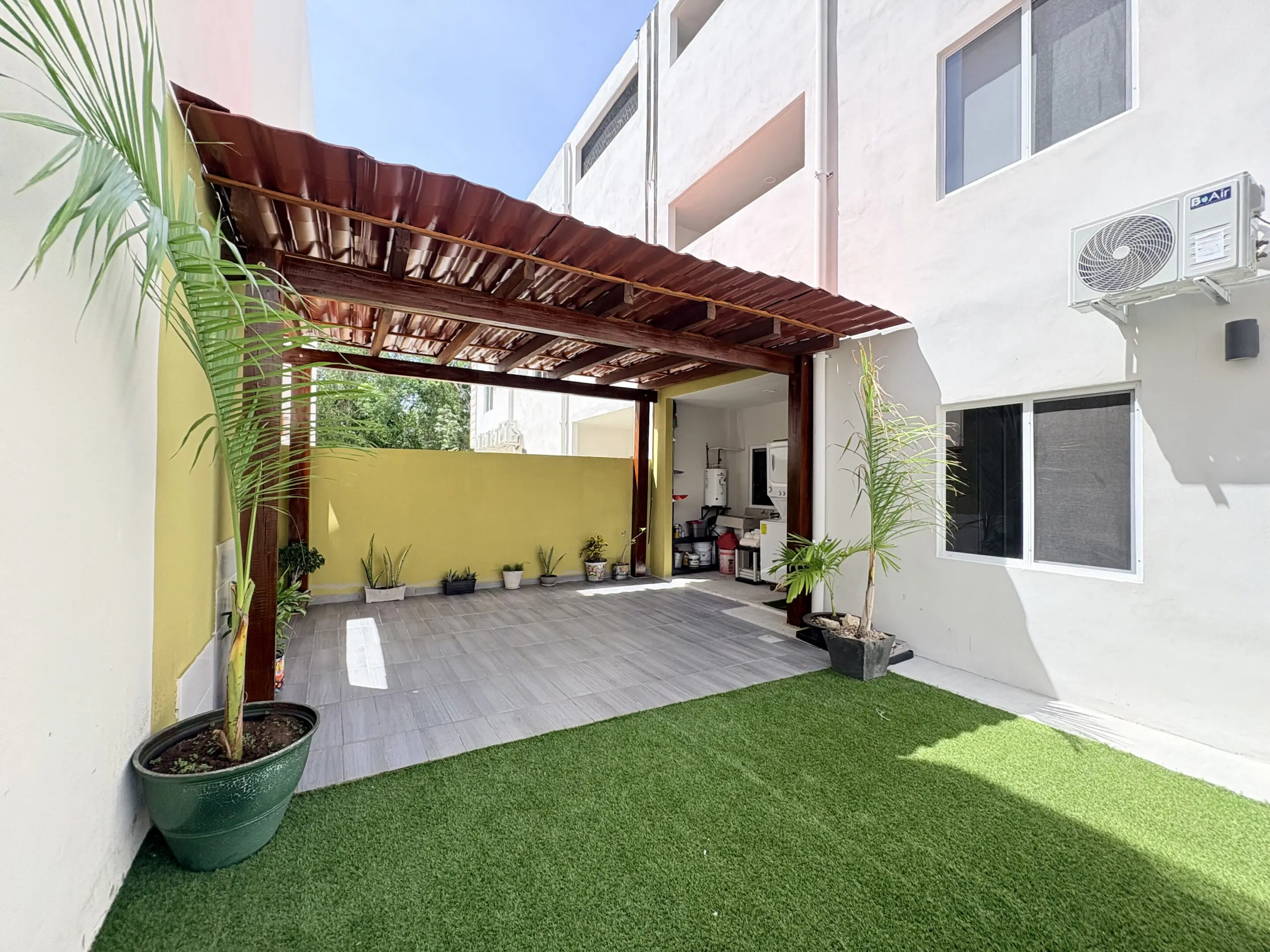 Patio with wooden pergola, potted plants