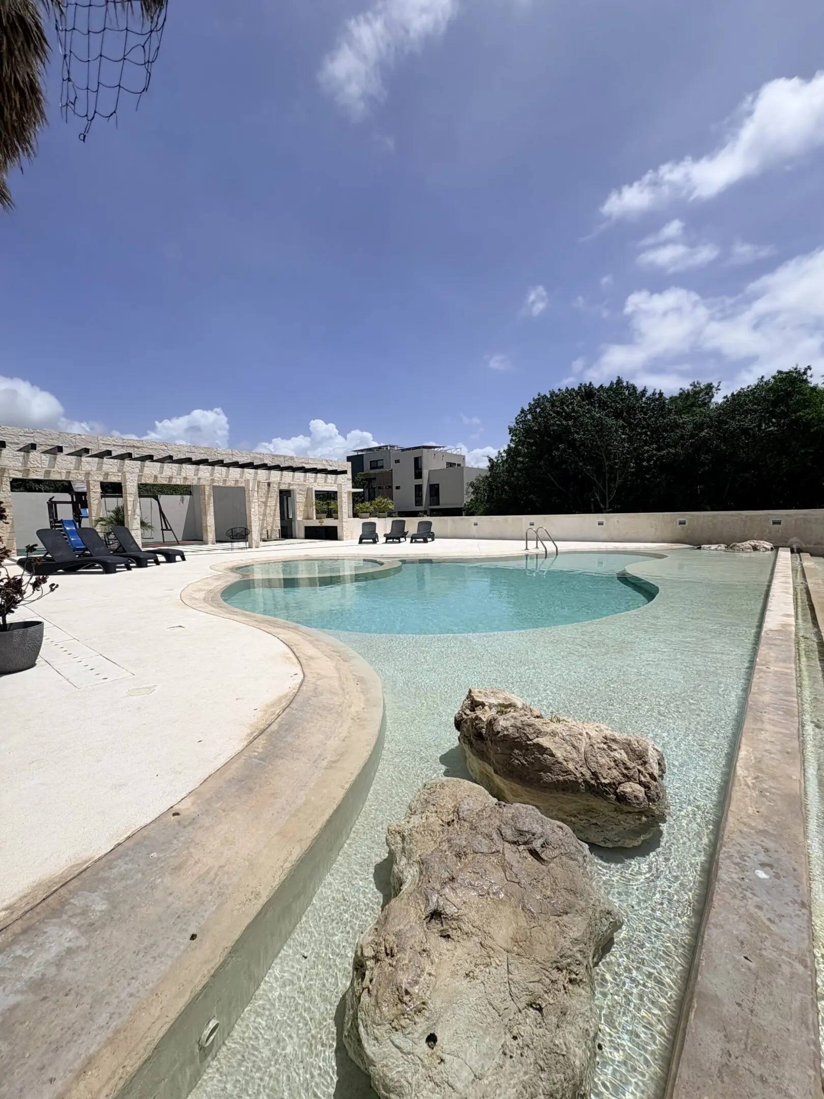 Resort pool with lounge chairs and rocks
