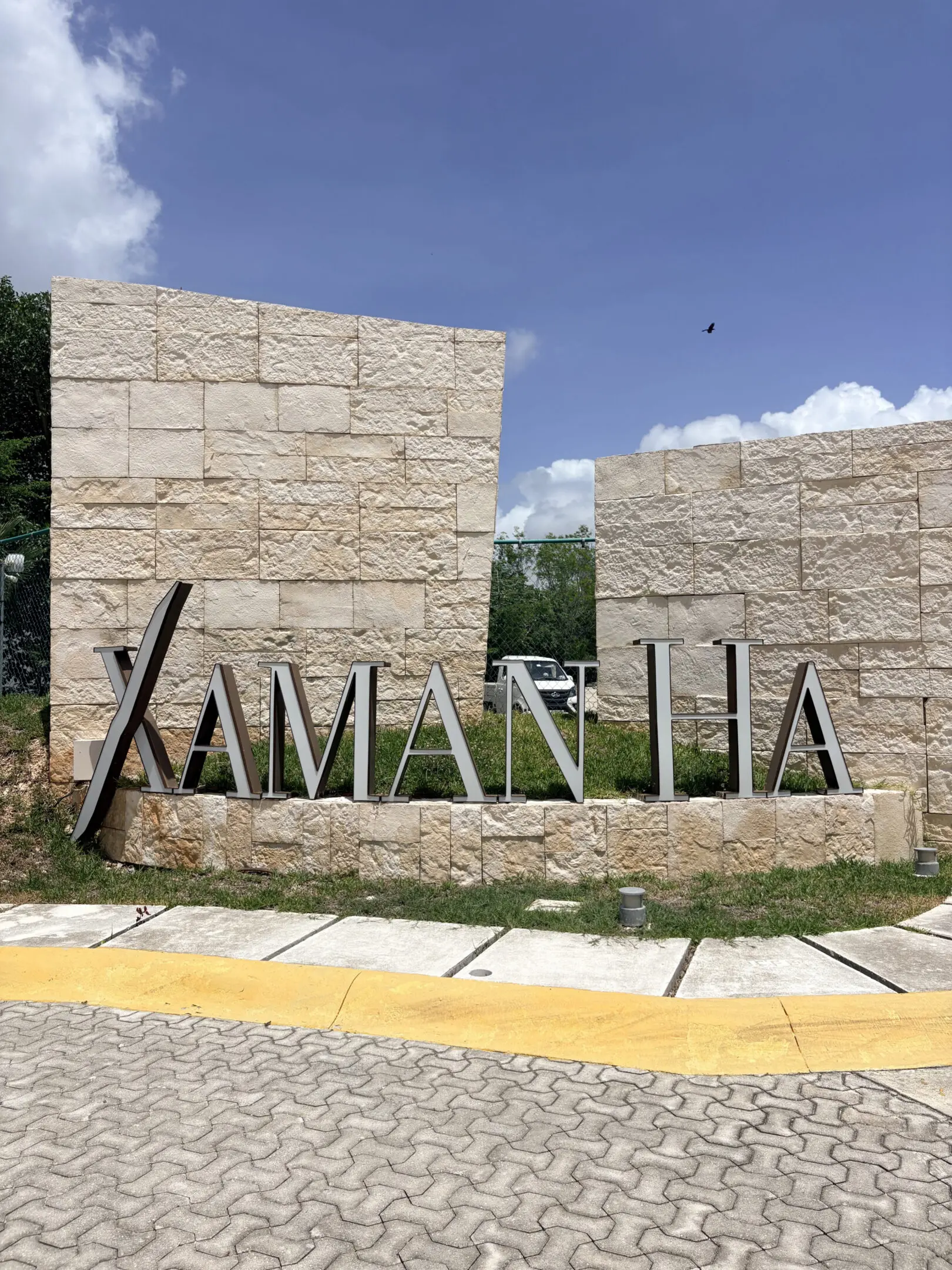Stone entrance sign reading Xaman Ha