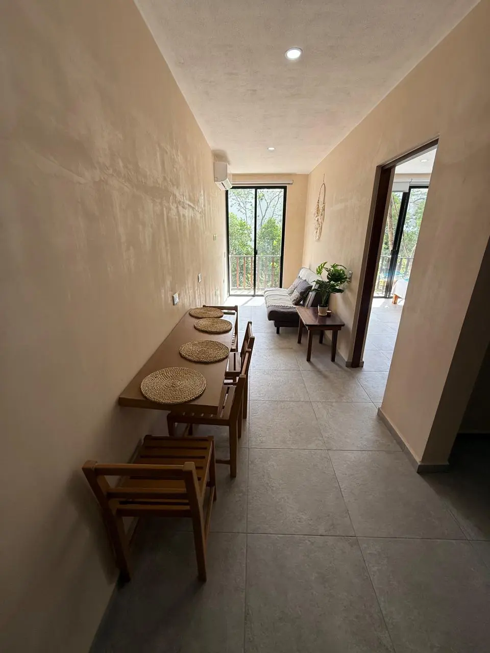 Narrow dining and living room with balcony