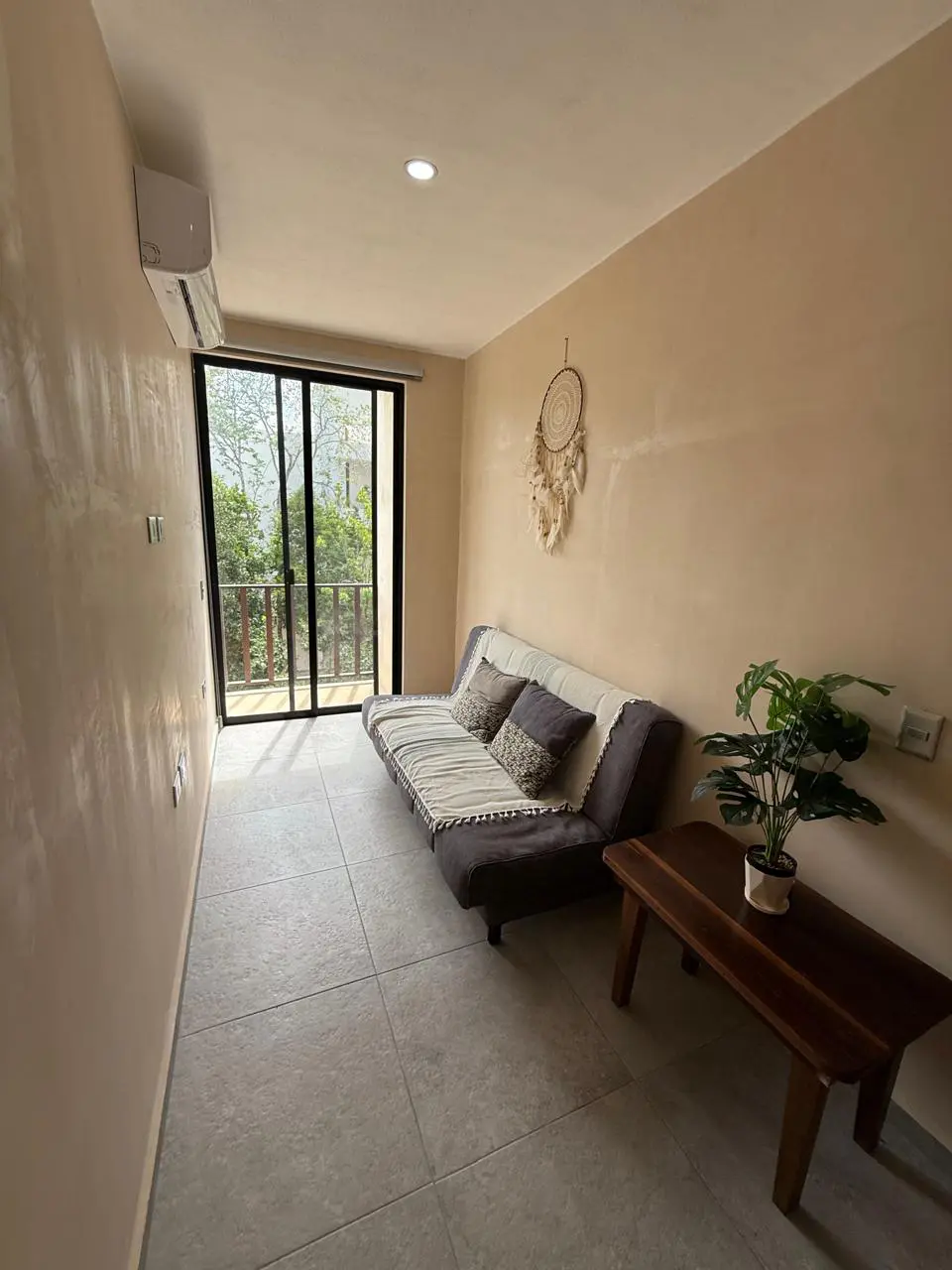 Cozy narrow living room with sofa and dreamcatcher