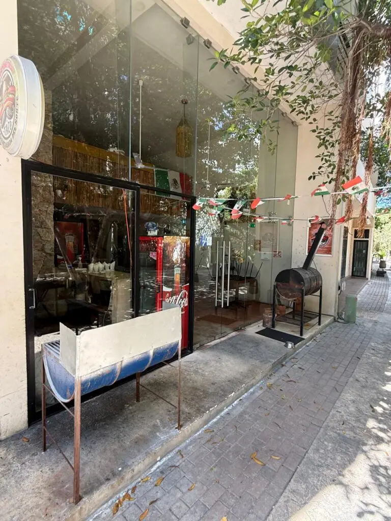 Glass-front restaurant with barbecue smoker outside