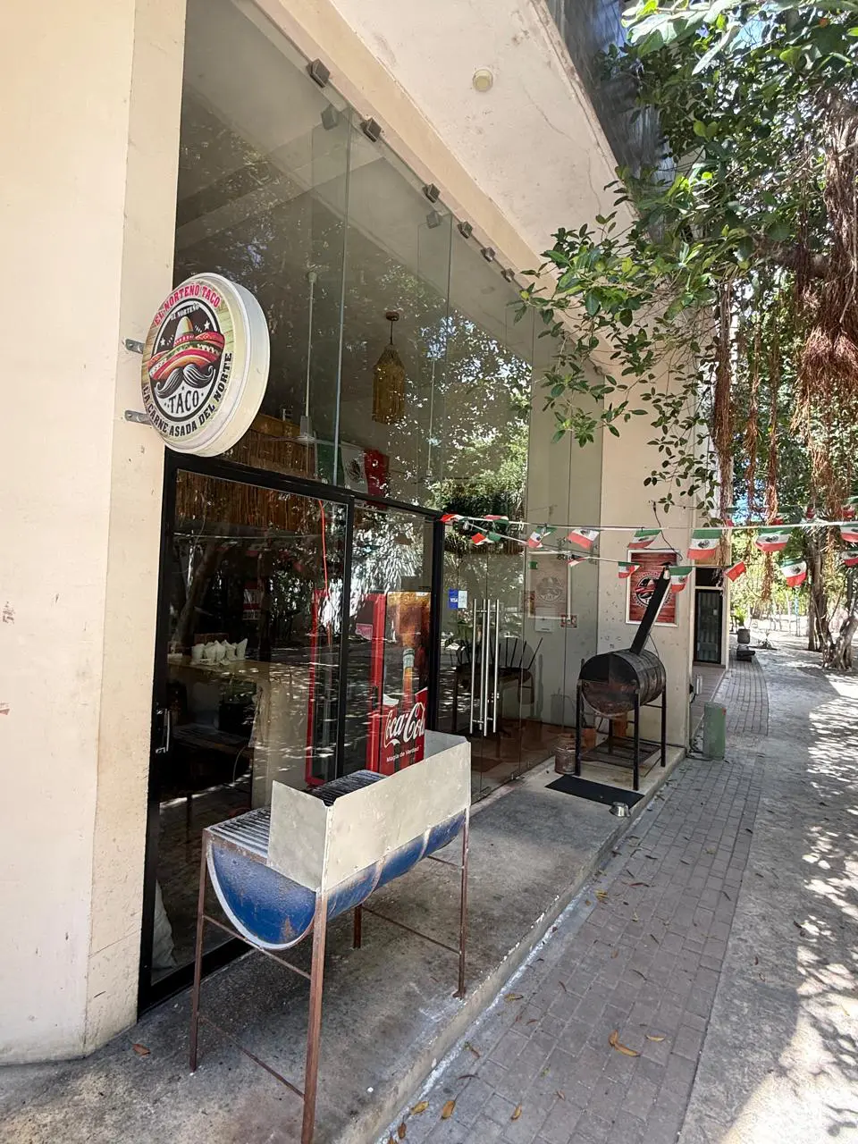 Taco restaurant storefront with outdoor seating