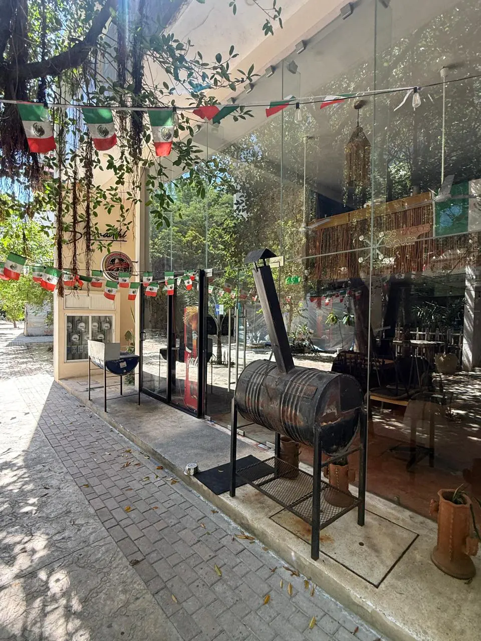 Mexican restaurant storefront with barrel smoker