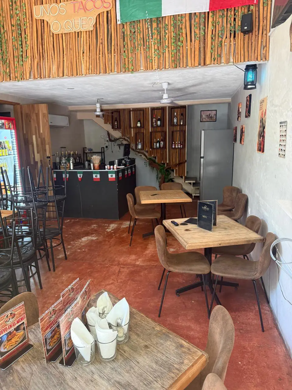 Cozy empty Mexican restaurant interior with wooden tables