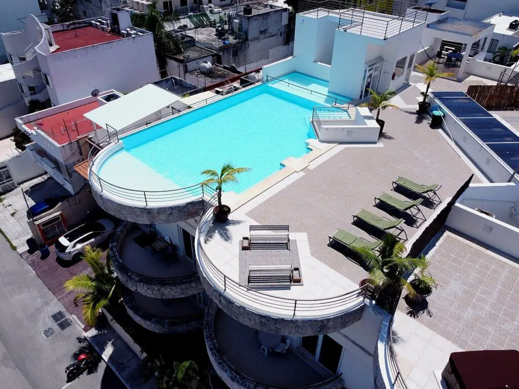 Rooftop swimming pool with lounge chairs