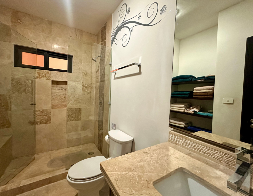Modern bathroom with walk-in shower and towels