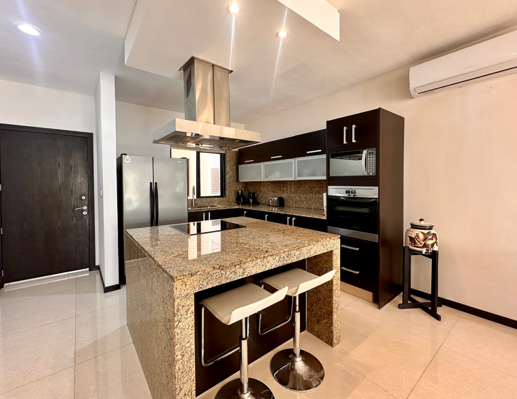 Modern kitchen with granite island and stools