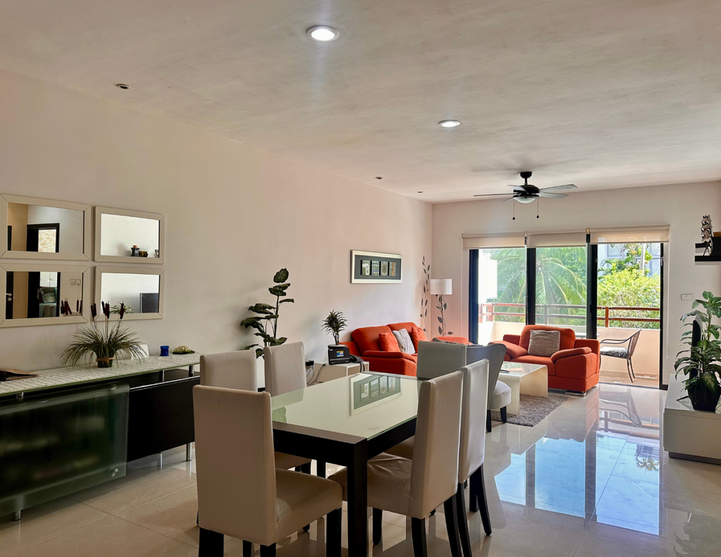 Modern open-plan living room with orange sofas