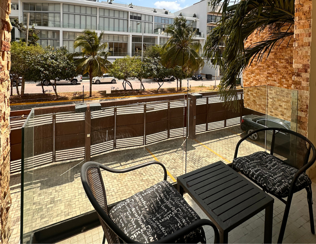 Balcony with chairs and table, palm trees