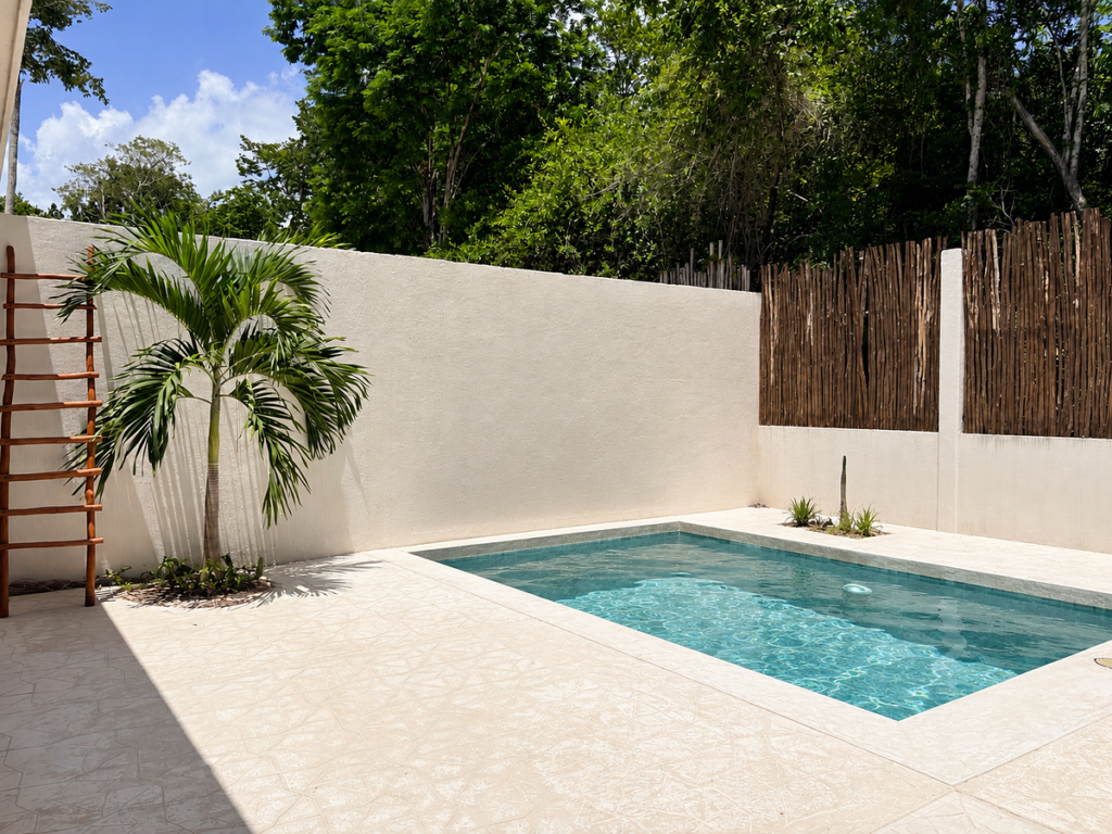 Small private courtyard pool with palm tree