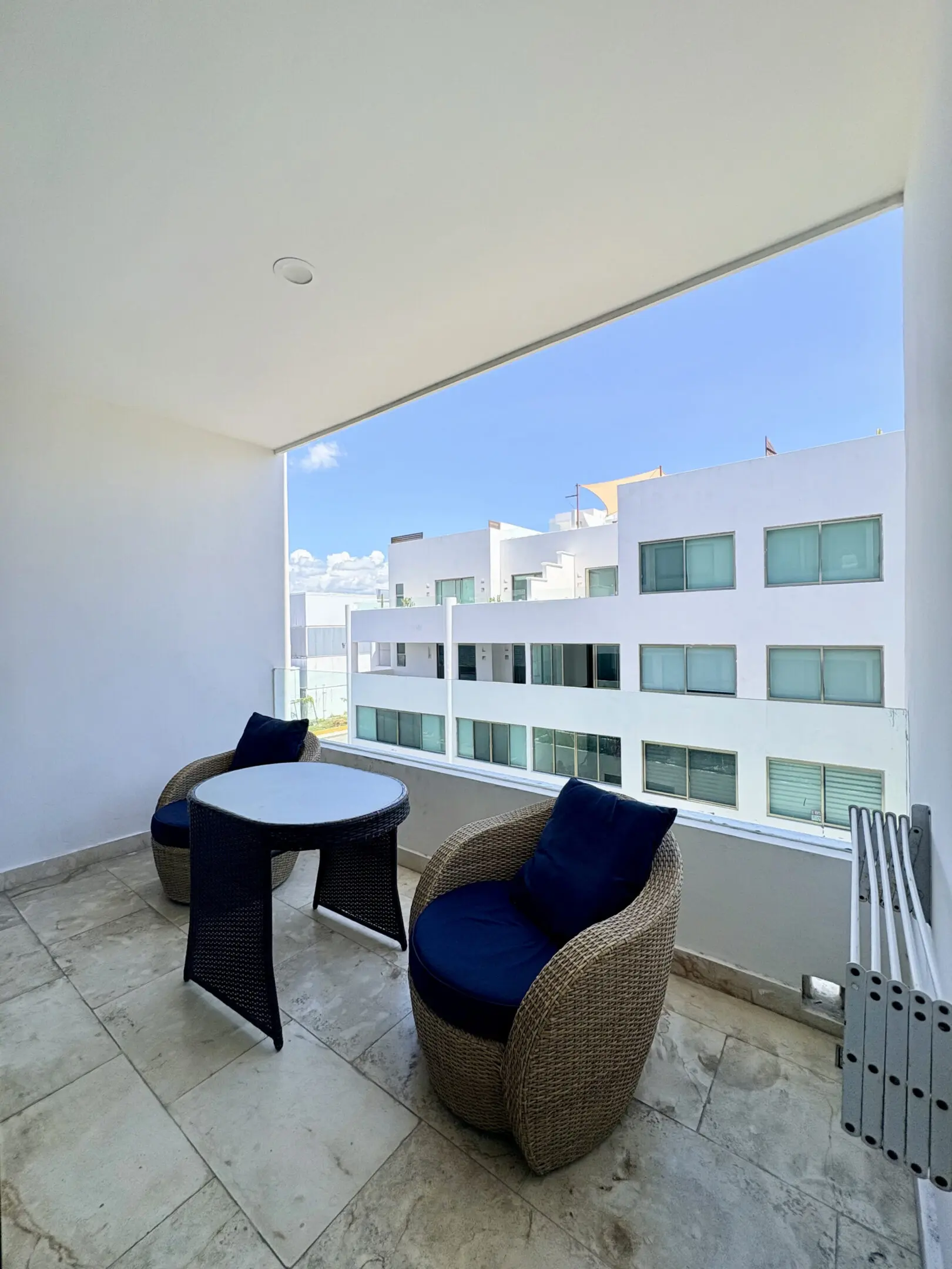 Balcony with two wicker chairs and table