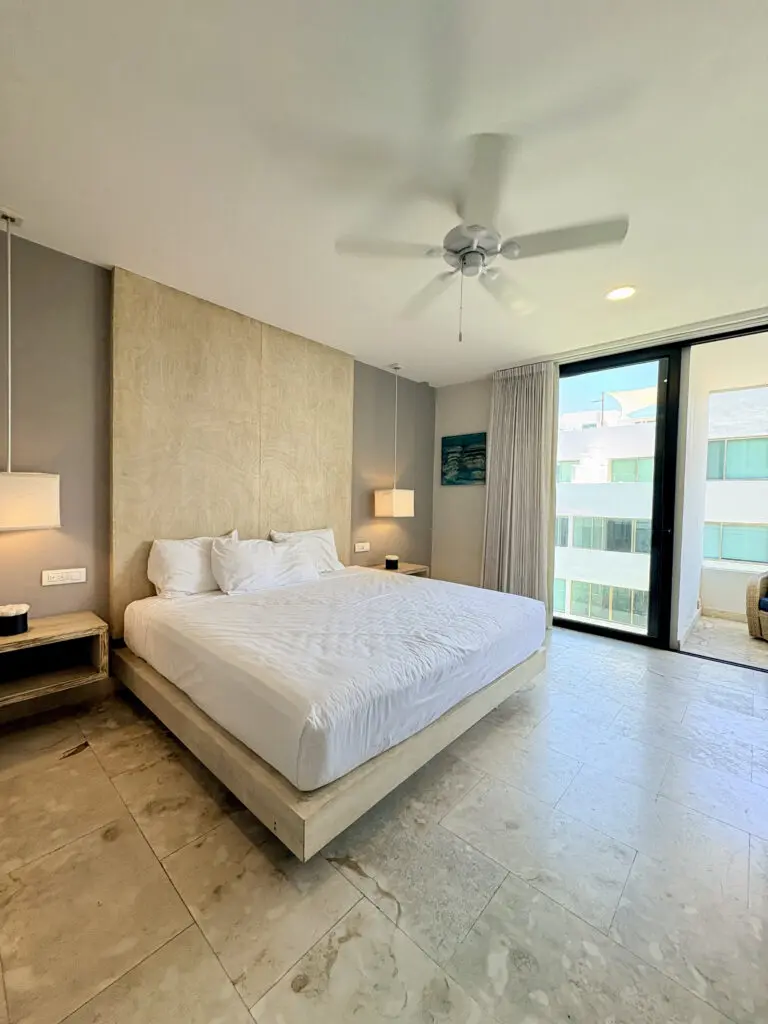 Modern bedroom with king bed and balcony