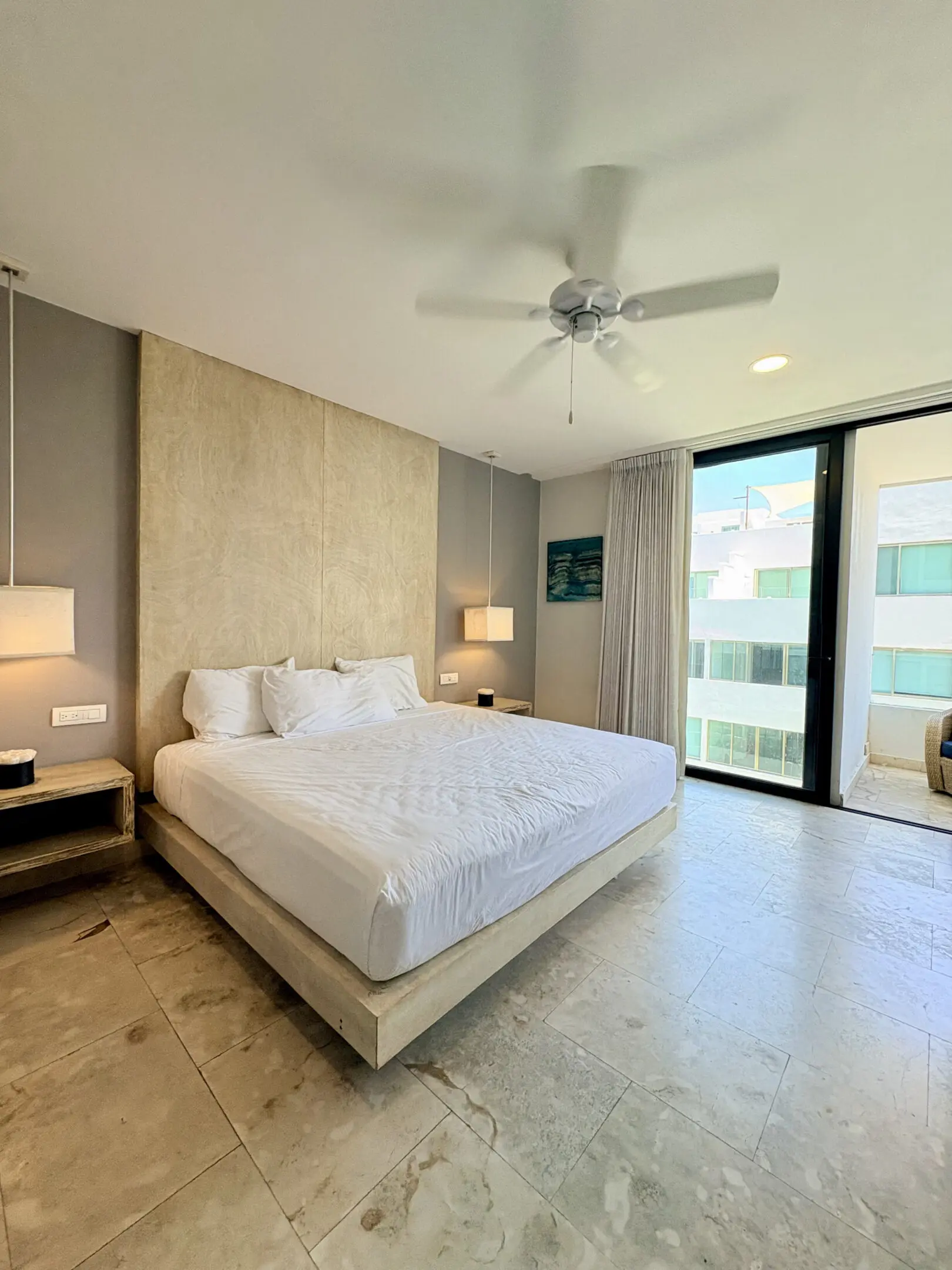 Modern bedroom with king bed and balcony