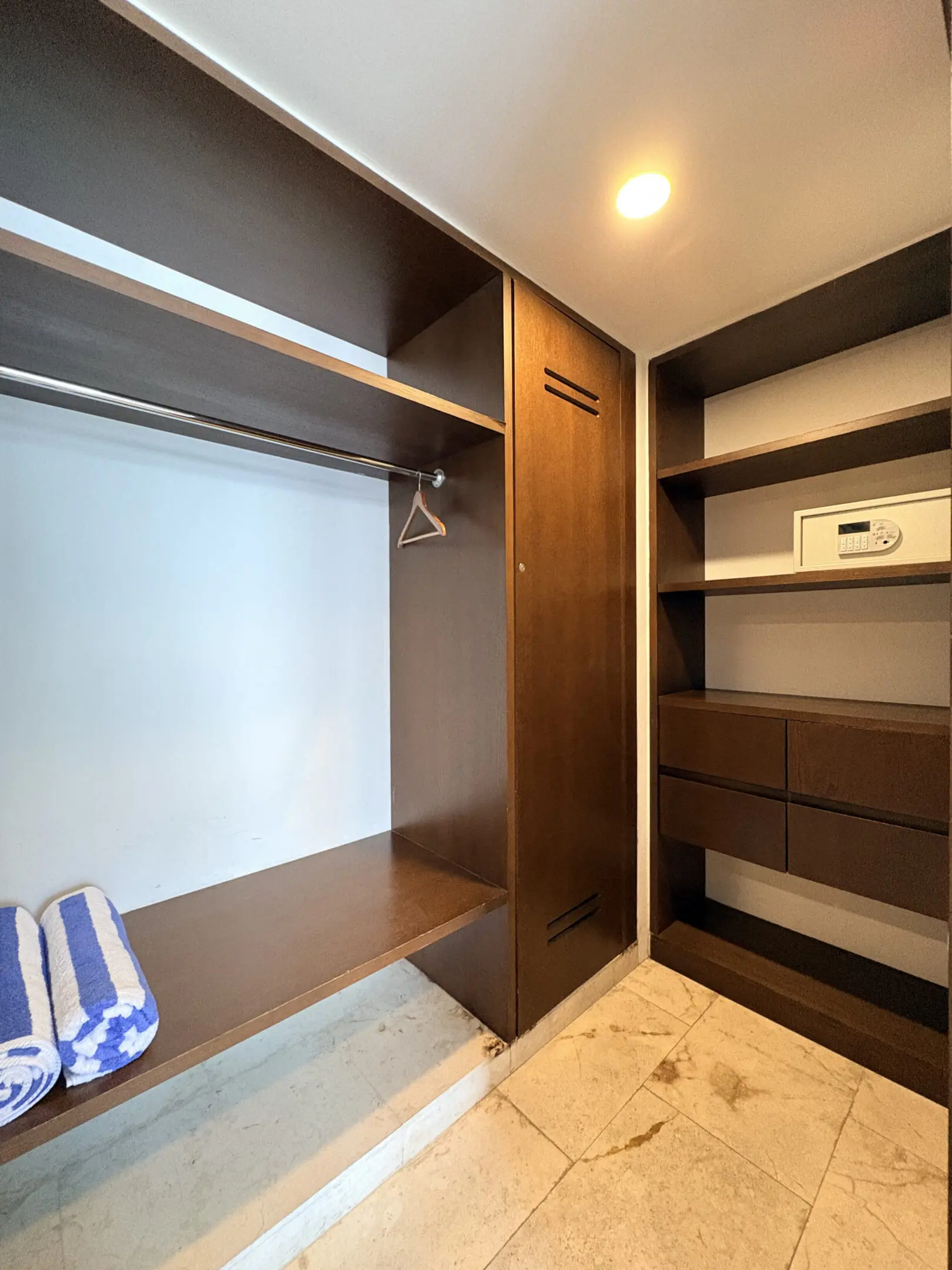 Wooden walk-in closet with shelves and safe