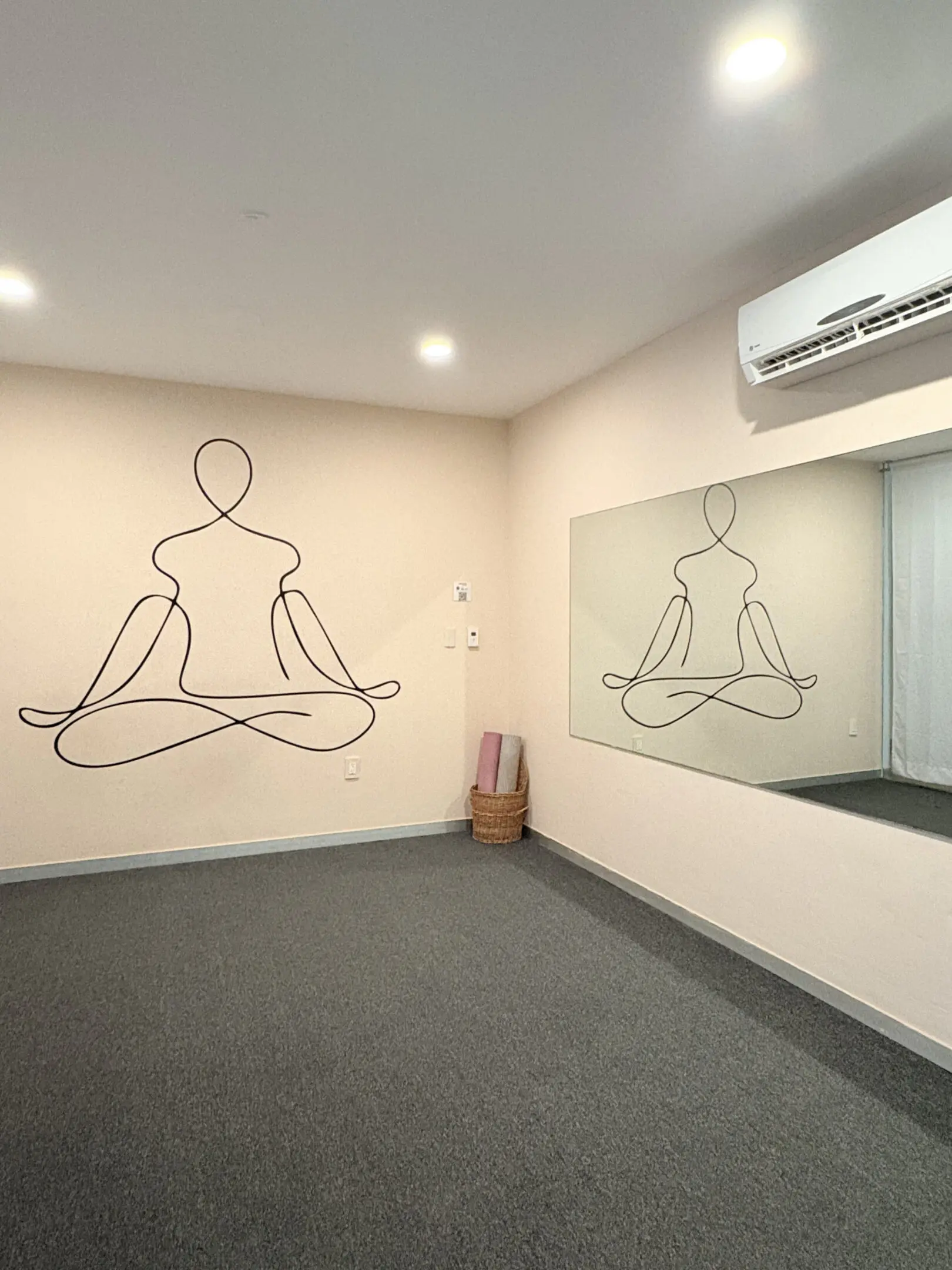 Yoga room with meditative line-art mural