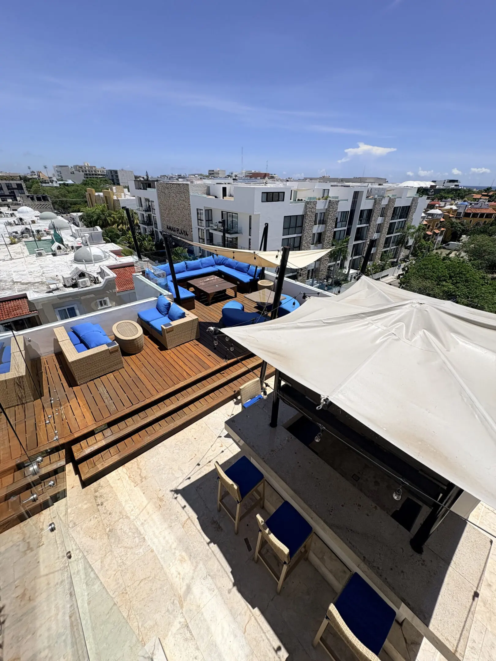 Rooftop lounge with blue seating and city skyline