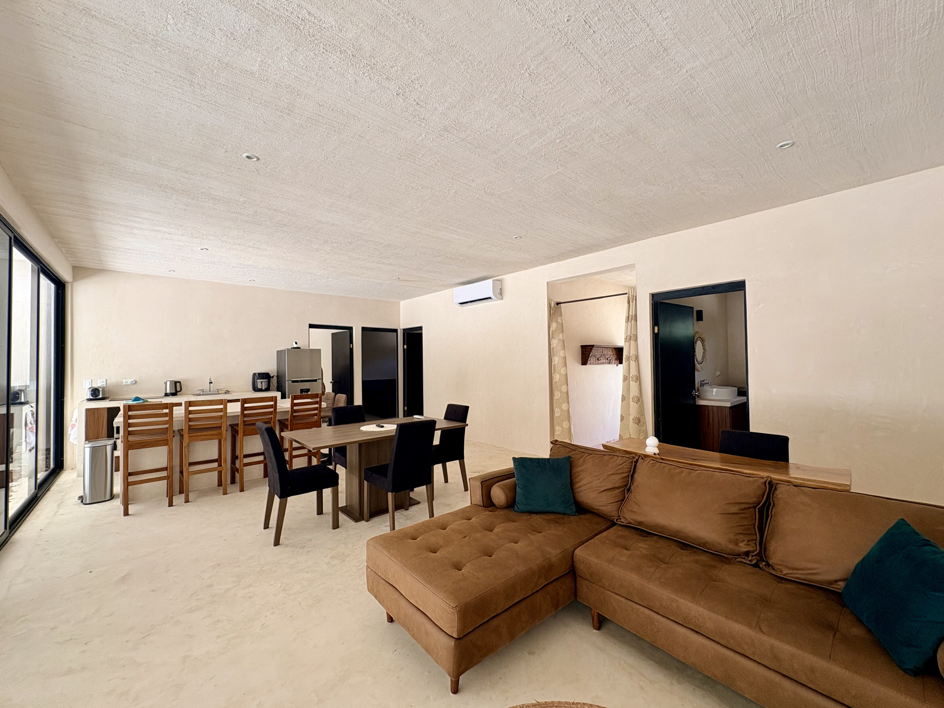 Open-plan living room with brown sectional sofa